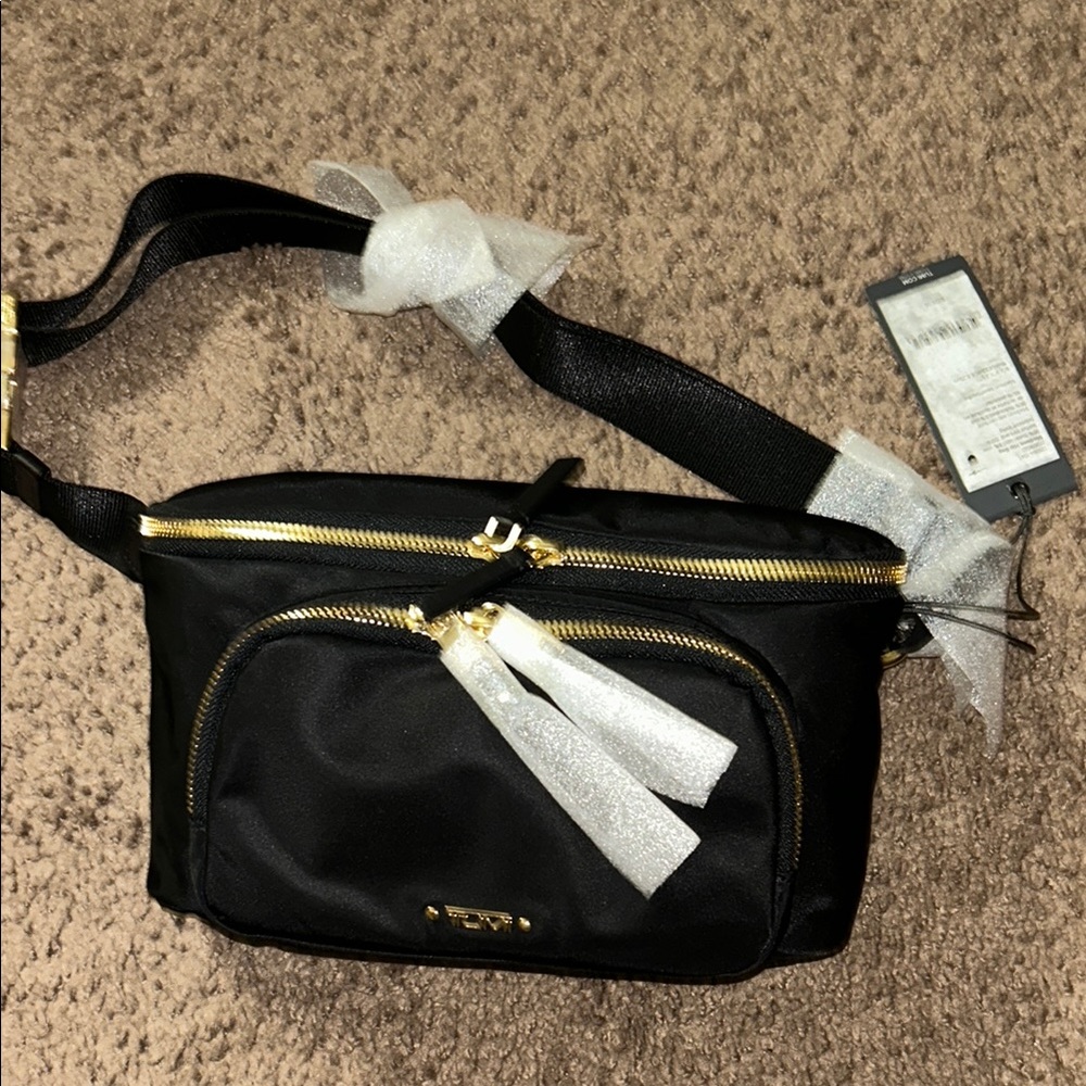 Tumi Black and Gold Crossbody Bag with Sleek Design